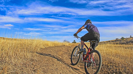 Fototapeta na wymiar Mountain biker on the Marshall Mesa Trail, Boulder, Colorado