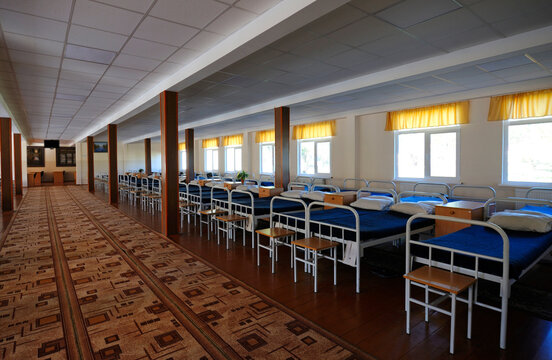 Bedroom of the barrack for soldiers well-made beds nightstands benches, nobody. Ukraine