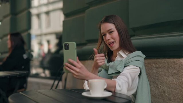 Female person with hearing loss using mobile for video call