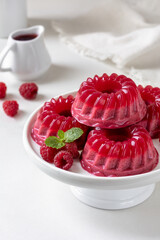 Raspberry jelly mousse or panna cotta made with pureed raspberries, sugar, cream, gelatine or agar...