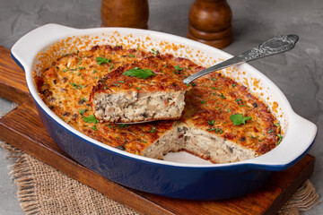 Sliced Creamy Mushroom Breakfast Casserole served in a baking dish. Closeup, selective focus, horizontal