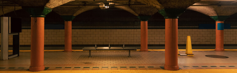 subway station with columns and tiled floor in New York City, banner.