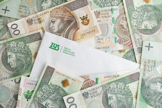 ZUS logo on envelope and Polish złoty money, PLN zloty banknotes. Letter from Polish National Social Insurance Institution, Zakład Ubezpieczeń Społecznych on February 4, 2023 in Krakow, Poland.