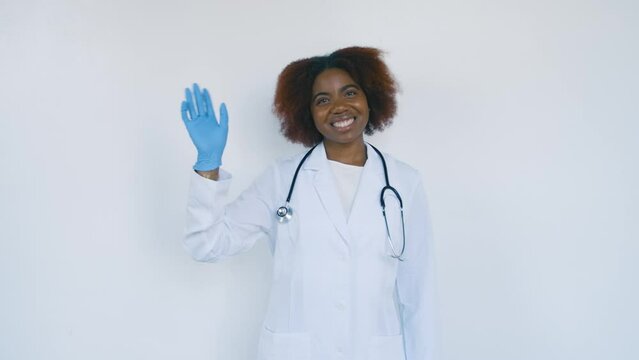 Black Stock Footage of millennial Black woman doctor working in a laboratory science coat in the hospital corridor hallway with natural light