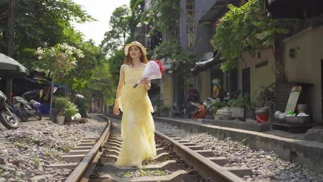 Portrait of Asian Vietnamese woman girl with train railway traveling in Hanoi urban city town, Vietnam. People lifestyle.