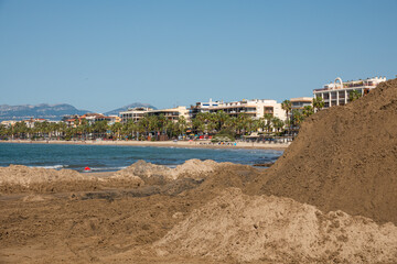 Fototapeta premium A mountain of wet sand at a construction site on the beach.