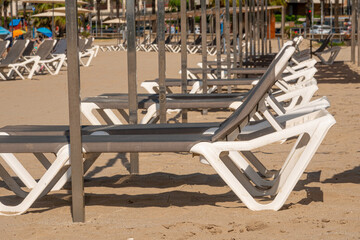 A row of empty sun loungers chairs