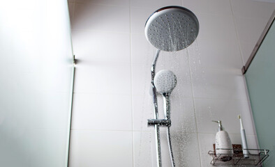 Jets of clean water flowing in the shower cabin. Selective focus.