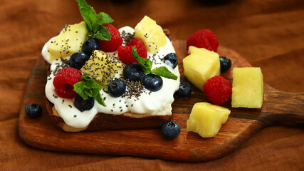 Healthy sweet toast with cream cheese, fruits, berries and chia seeds. Keto dessert.
