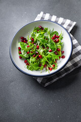 pomegranate salad green leaves, pomegranate seed,  lettuce mix healthy meal food snack on the table copy space food background rustic top view 