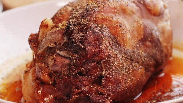 Roasted pork knee on dish, traditional czech republic food, German pulled pork.