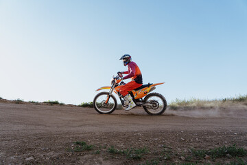 Plakat Man riding motorbike on motocross track.Extreme and Adrenaline. Motocross rider in action. Motocross sport. Active lifestyle