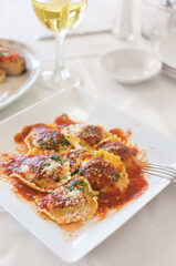 Veal Ravioli with marinara sauce with mozzarella, basil and parmesan cheese