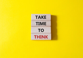 Take time to think symbol. Wooden blocks with words Take time to think. Beautiful yellow background. Business and Take time to think concept. Copy space.