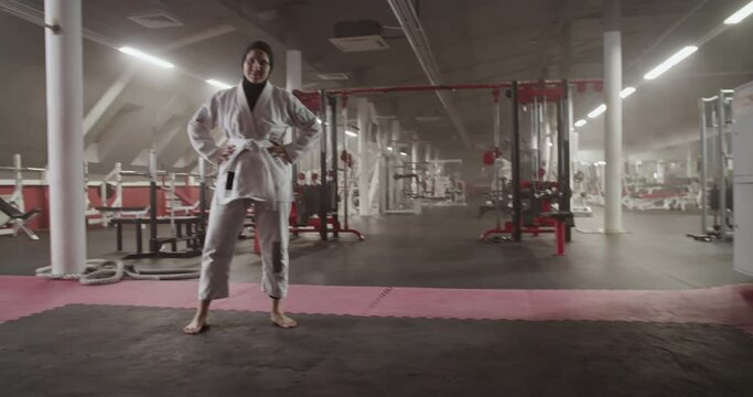 Barefoot BJJ fighter with crossed arms