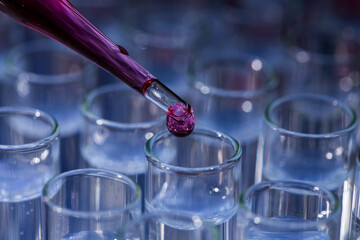 Pipette dropping fluid into test tube