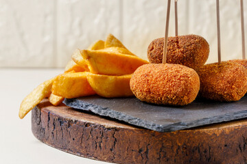 Close up view of snack of ham croquettes and chips