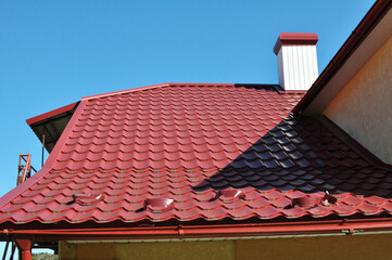 The roof of the house is covered with metal tiles