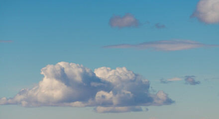 Beautiful huge fluffy clouds on the blue sky. Sky clouds background.