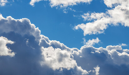 Beautiful huge fluffy clouds on the blue sky. Sky clouds background.