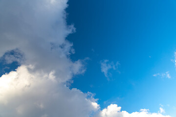 Beautiful huge fluffy clouds on the blue sky. Sky clouds background.