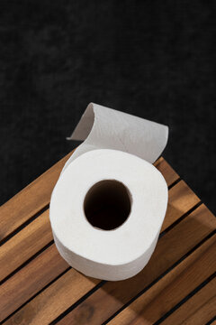 White toilet paper on a wooden table. Top view.