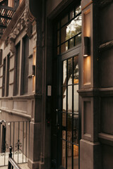grey building with lamps near glass door in Brooklyn Heights district of New York City.