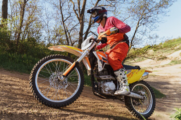 Fototapeta premium Man riding motorbike on motocross track.Extreme and Adrenaline. Motocross rider in action. Motocross sport. Active lifestyle