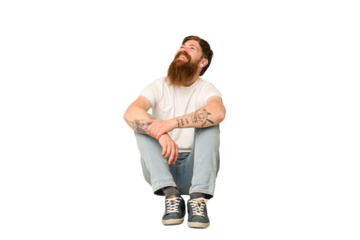 Adult redhead man sitting on the floor isolated