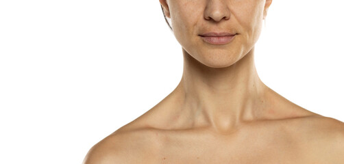 mouth, neck and bare shoulders of a woman without makeup on a white background