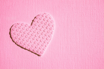 cute pink heart made of textured material on table, art card, copy space.
