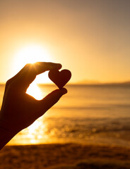Love heart on a tropical beach at sunset. 