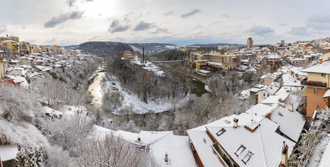 City of Veliko Tarnovo in winter covered with snow. Monument to the Assen Dynasty and Yantra river in distance. Bulgaria, Europe.