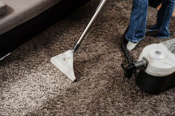 Line on carpet after spraying water of dry cleaning extractor mop machine close-up. Domestic...