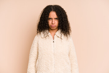 Young african american curly woman isolated sad, serious face, feeling miserable and displeased.