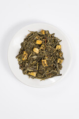 Green tea with aromatic additives. Top view on white background
