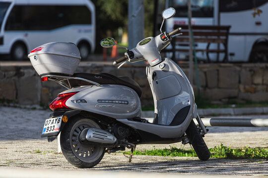 Side, Turkey -January 27, 2022:   silver  Arora Cappucino  is parked  on the street on a warm day against the backdrop of a fence, garden