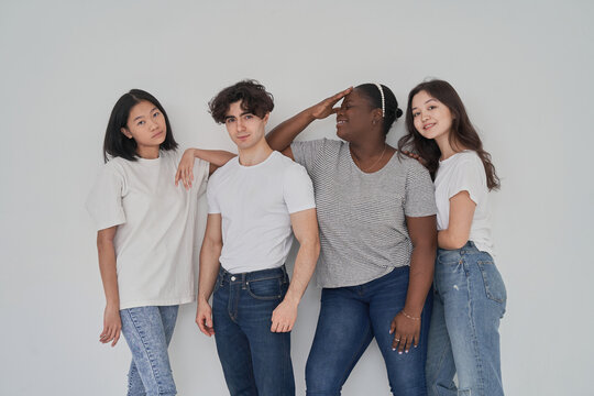 Positive diverse people near wall