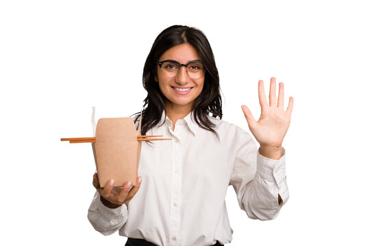 Young Business Indian Woman Eating Takeaway Noodles Cut Out Isolated Smiling Cheerful Showing Number Five With Fingers.