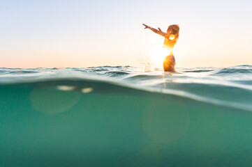 Joyful child silhouette at the beach
