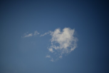 rays of the sun through the cirrus clouds against the blue sky, white rainy clouds blue sky...