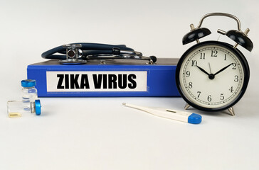 On a white surface, a thermometer, a stethoscope and a folder with the inscription - Zika virus