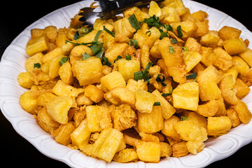Fried Brazilian manioc, traditional food from Brazil, in an artisan clay bowl, typical Brazilian tradition from Minas Gerais