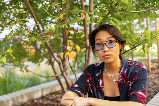 Asian Woman In A Green Garden