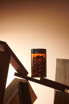 pills fly into the dark jar on wooden geometric shapes