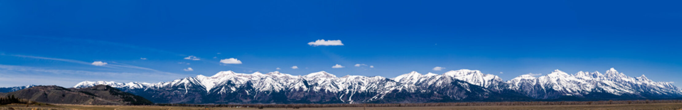 A multi photo panorama of the Grand Teton Mountain Range.
