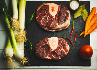 vegetables  and ossobuco on a wooden board