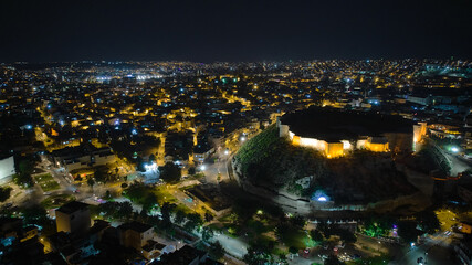 Naklejka premium Illuminated Gaziantep Castle and night city lights aerial view. July 2022