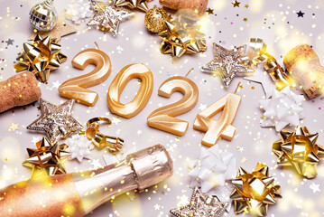 Holiday background Happy New Year 2024. Numbers of year 2024 made by gold candles on bokeh festive...
