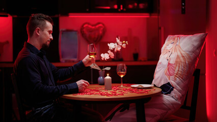 Man and anime waifu dakimakura having a romantic Valentine's dinner at home